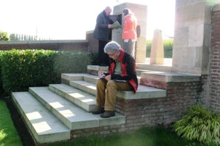 CIMG8656 Sep 9 2017 Pieter writes in guest register at La Laiterie Cemetery Francois and Mieke in back