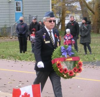 CIMG5391 Nov 11 2021 Pieter walks with Govt of Canada wreath Borden Carleton